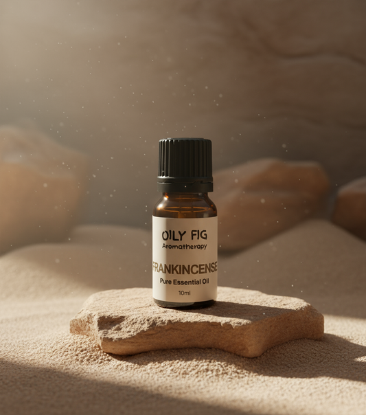 Bottle of Frankincense essential oil on a stone surface with a blurred natural background